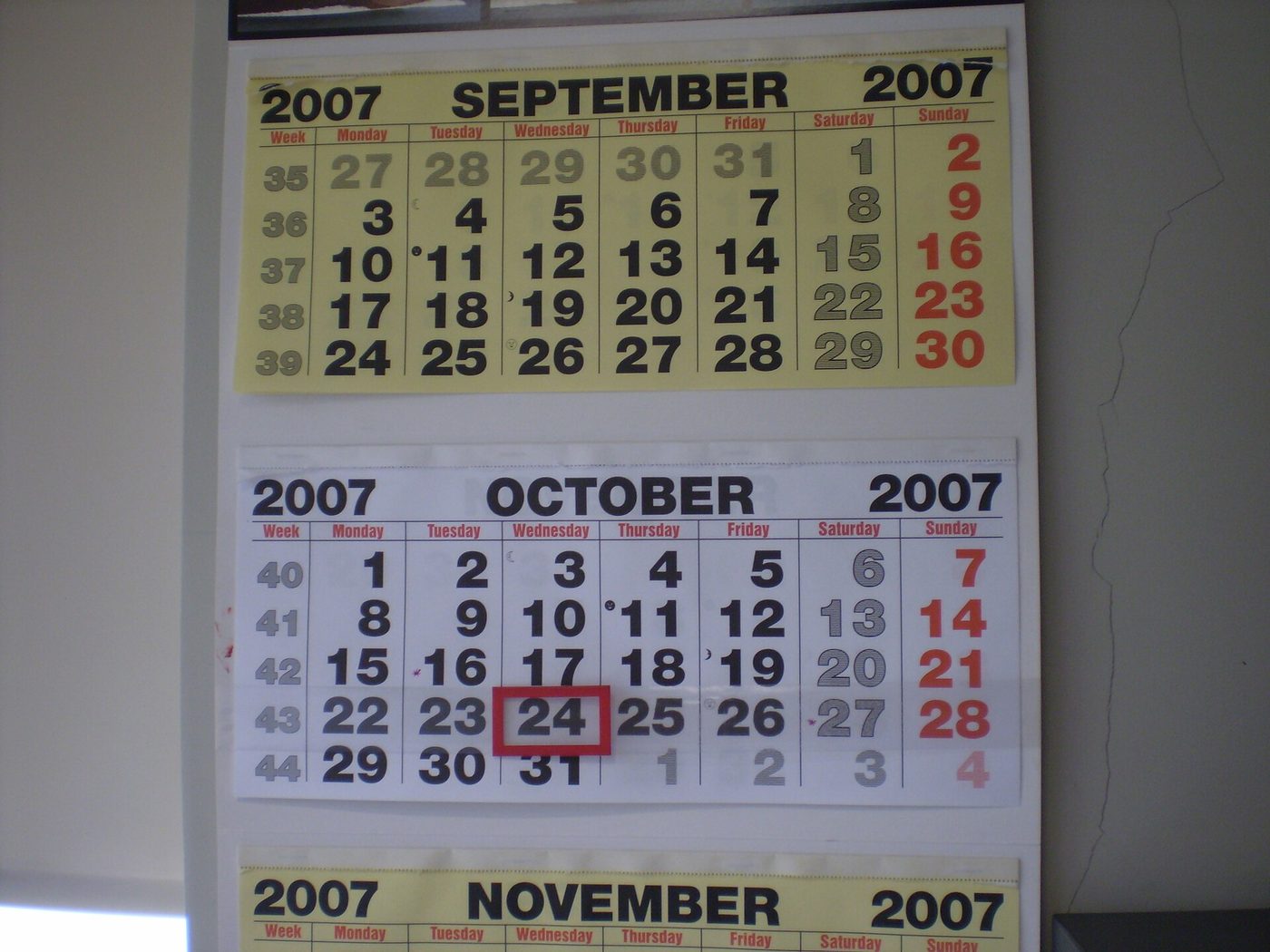 A printed wall calendar showing September, October and November, with one date in October circled in red.