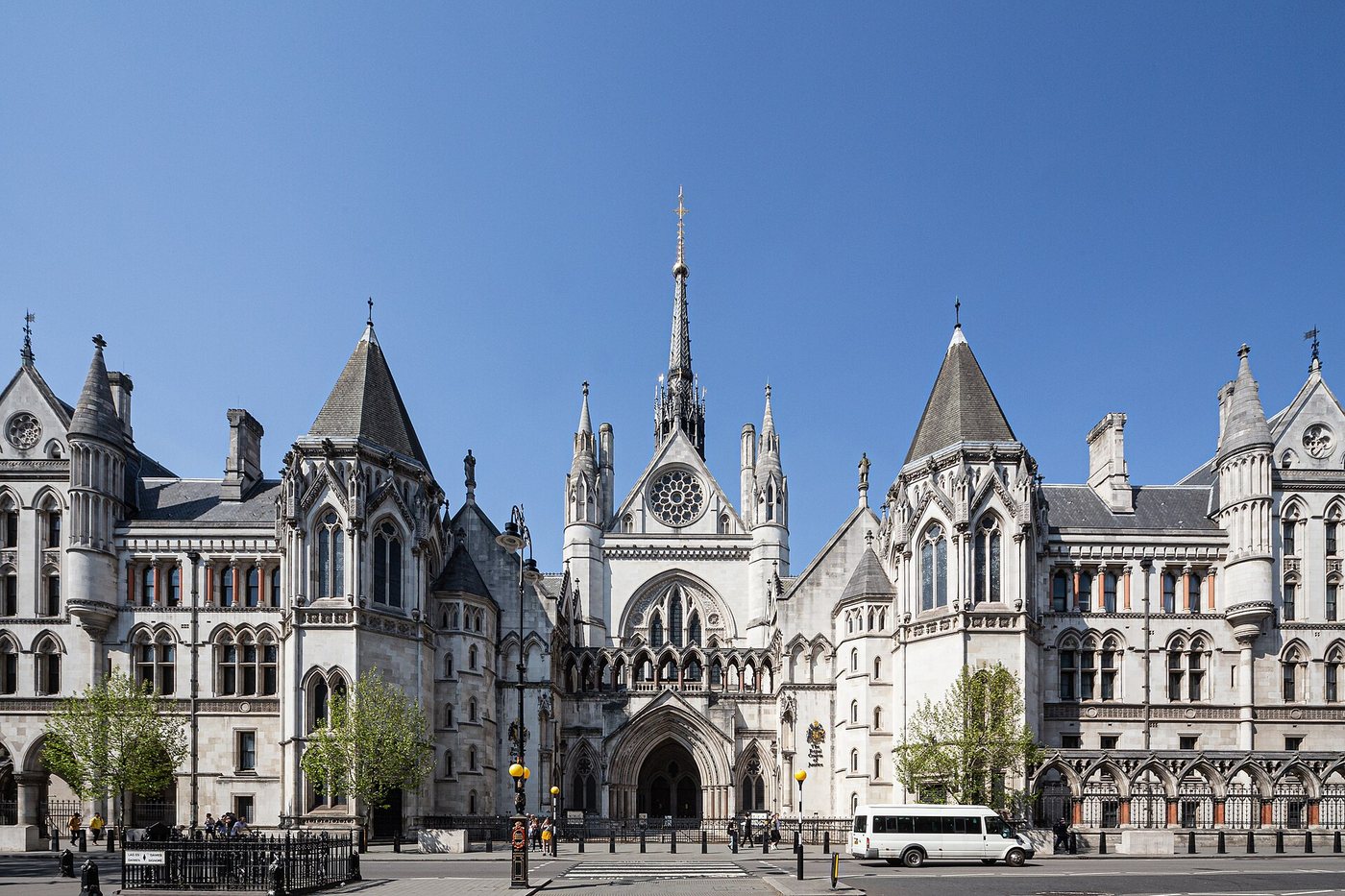 L’entrée principale néogothique des Royal Courts of Justice, sur le Strand, à Londres, sous un ciel bleu dégagé.